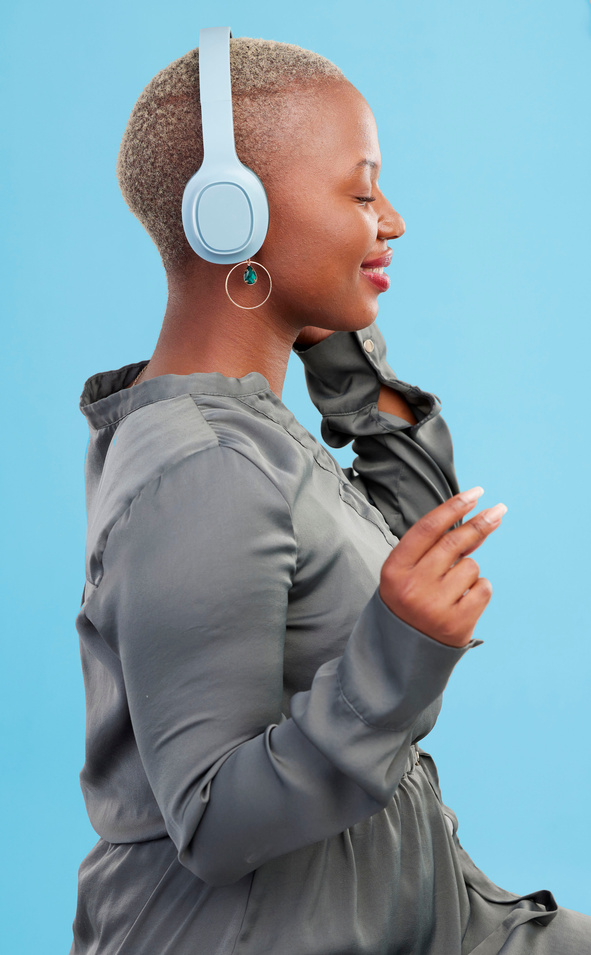 Black Woman, Headphones and Music, Profile and Technology with Audio Streaming Isolated on Blue Background. Listening to Radio, Wireless Tech for Podcast and Subscription with Peace in Studio