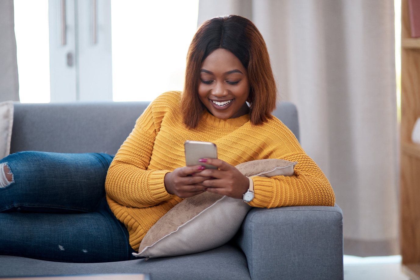 Black Woman with Smartphone, Chat on Social Media and Relax at Home, Smile with Online Communication. African Female Person, Mobile App with Text Message or Post Update with Connectivity in Apartment