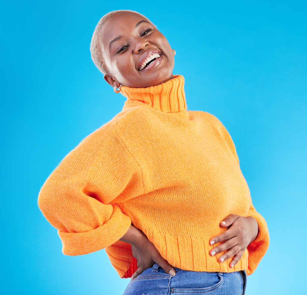 Studio, Blue Background and Happy African Woman with Fashion, Natural Beauty and Confidence in Casual Style or Clothes. Portrait, Smile and Person with Happiness in Winter Clothing or College Student