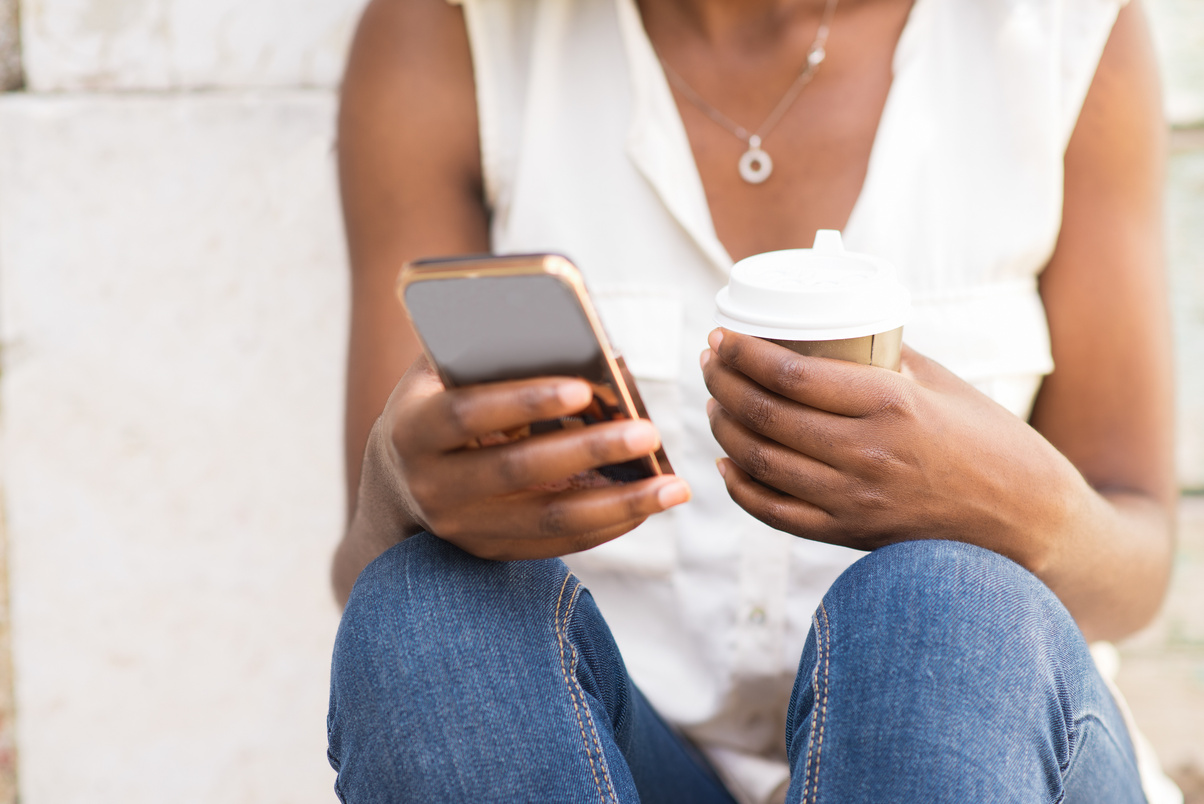 Female Hands Holding Phone and Coffee